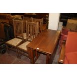AN OAK DROP LEAF TABLE AND FOUR CHAIRS