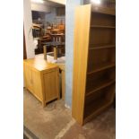 A LARGE LIGHT OAK DINING ROOM TABLE + A GLASS TOP COFFEE TABLE + A LIGHT OAK OPEN FRONTED BOOKCASE