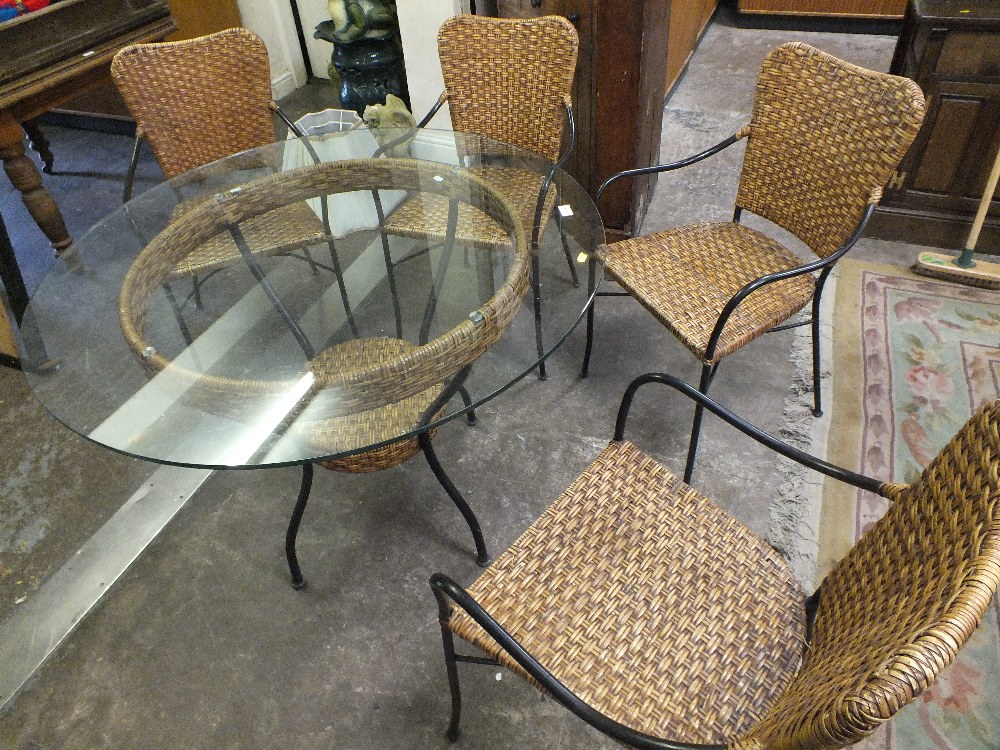 A GLASS TOPPED CONSERVATORY TABLE AND FOUR ARMCHAIRS