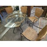 A GLASS TOPPED CONSERVATORY TABLE AND FOUR ARMCHAIRS