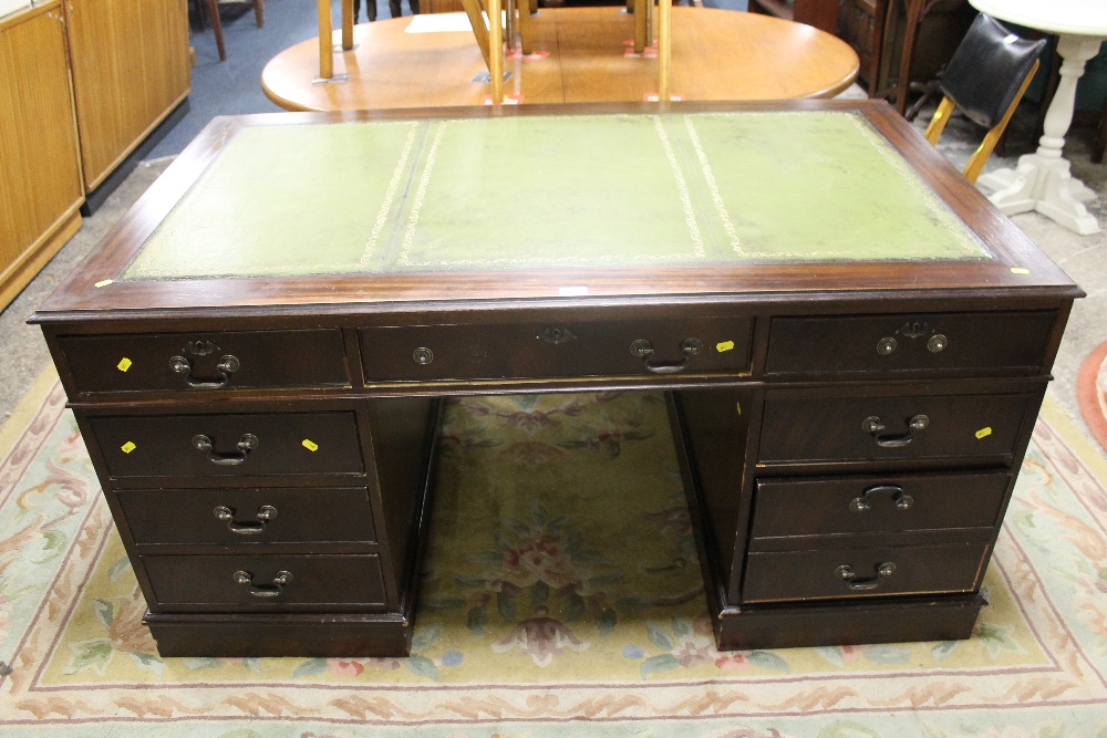 A LEATHER TOPPED TWIN PEDESTAL DESK