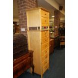 A LIGHT WOOD TALL CHEST OF SEVEN DRAWERS TOGETHER WITH A TWO DRAWER SIDE TABLE