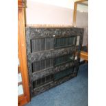 A CARVED EBONISED OAK SLIDING DOOR DISPLAY CABINET