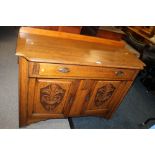 A CARVED OAK SIDEBOARD