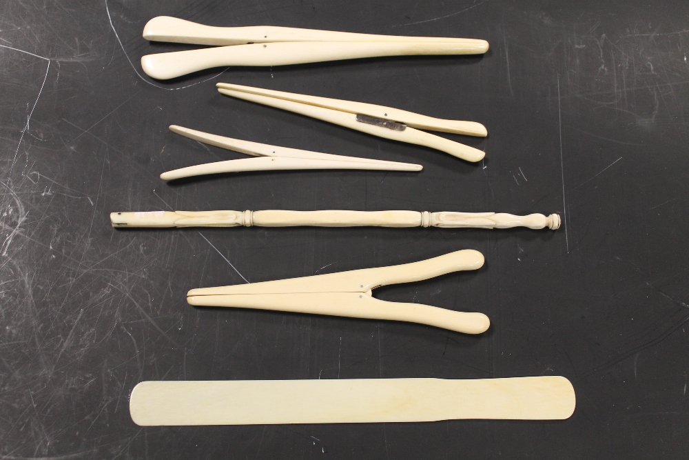 FOUR IVORY GLOVE STRETCHERS, a fan handle and a page turner (6)