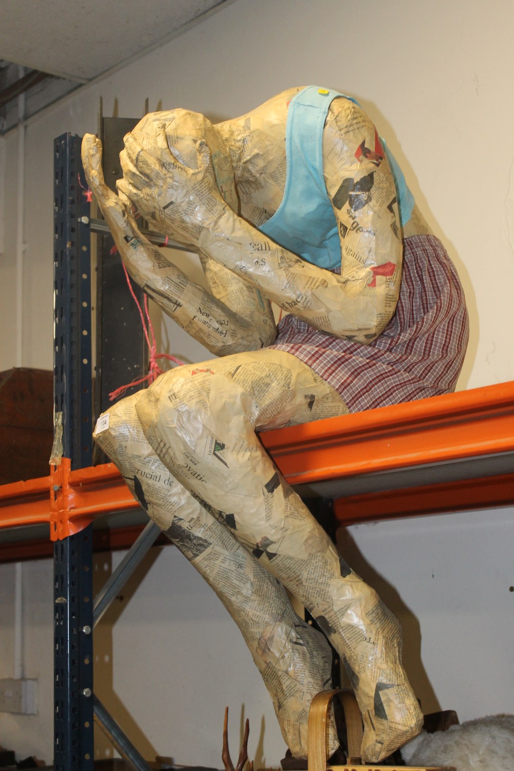 A PAPER MACHE MODEL OF A PERSON WEEPING