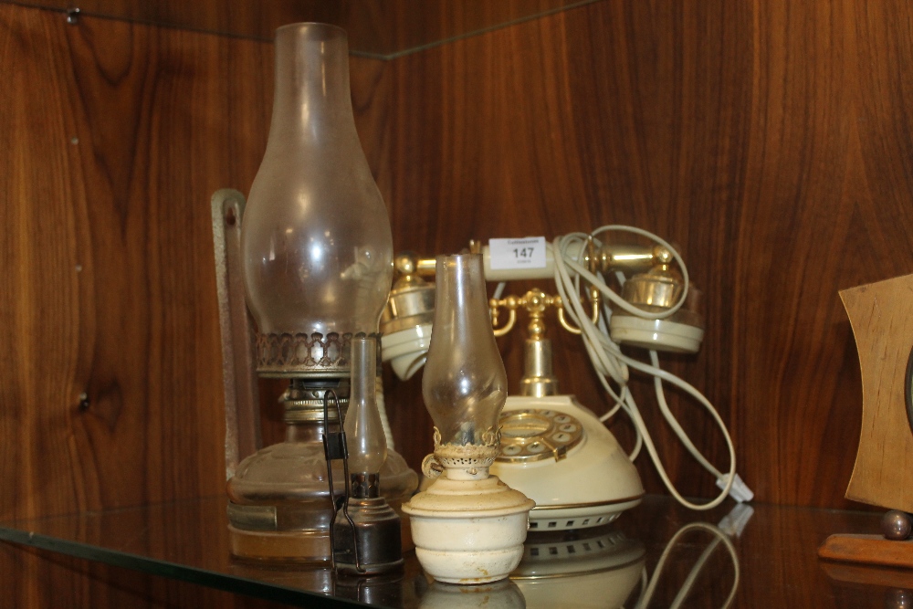 A SLOANE TELEPHONE & THREE OIL LAMPS