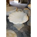 A LARGE STONE SHELL BIRD BATH ON A DECORATIVE BASE