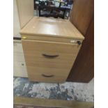 A LIGHT WOOD EFFECT FILING CABINET