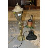 AN UNUSUAL BRASS LAMP TOGETHER WITH A FLORALLY SHADED FIGURATIVE EXAMPLE