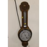 A WALL HANGING BAROMETER