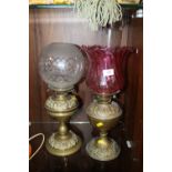 TWO VINTAGE OIL LAMPS, ONE WITH A PINK GLASS SHADE