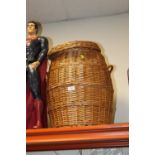 A WICKER SNAKE CHARMER LAUNDRY BASKET