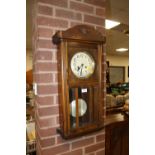 AN EDWARDIAN OAK CASED WALL CLOCK