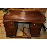 A MAHOGANY TWIN PEDESTAL ROLL TOP DESK