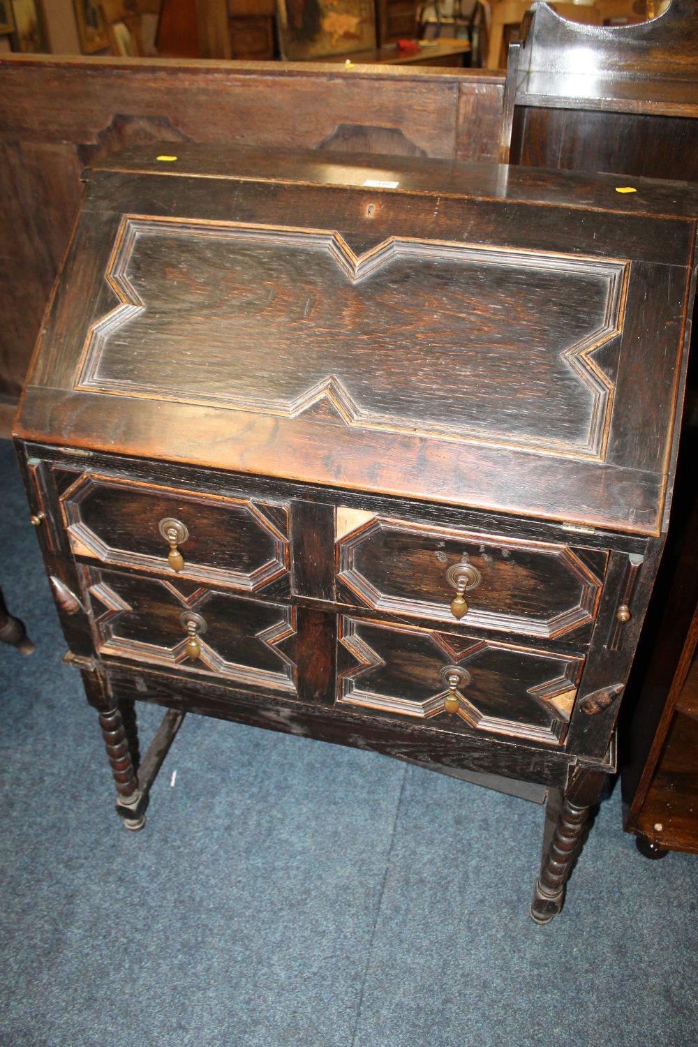 AN OAK BUREAU WITH BARLEYTWIST SUPPORTS