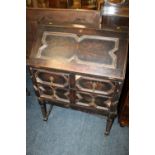 AN OAK BUREAU WITH BARLEYTWIST SUPPORTS