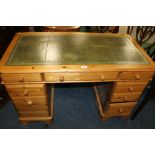 A PINE TWIN PEDESTAL DESK WITH GREEN LEATHER TOP