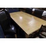 A MODERN OAK DINING TABLE WITH FOUR UPHOLSTERED CHAIRS