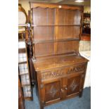 AN OAK WELSH DRESSER WITH CARVED DETAIL