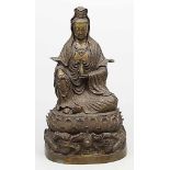 Guanyin-Skulptur. Bronze, dunkel patiniert. Die Gottheit sitzt mit dem re. aufgestellten Knie auf