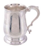An George III baluster mug probably by John King,   London 1772, with a leaf-capped double scroll