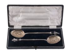 A pair of silver parcel gilt berry spoons probably by James Reid  &  Co.,   Glasgow 1909 and 1911,