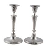 A pair of late Victorian silver candlesticks by William Hutton  &  Sons Ltd.,   London 1900, the