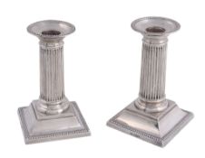A pair of silver small columnar candlesticks by William Hutton  &  Sons,   Sheffield 1919, with