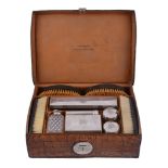 A Victorian crocodile skin gentleman's travelling case with silver mounted fittings by W.  &  G.