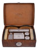 A Victorian crocodile skin gentleman's travelling case with silver mounted fittings by W.  &  G.