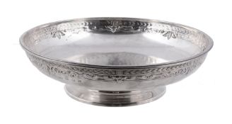 A silver circular fruit bowl by Elkington  &  Co.,   Birmingham 1937, with chased foliate bands, on