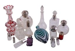 A collection of glass scent bottles some silver mounted,   including: a Nailsea type green and