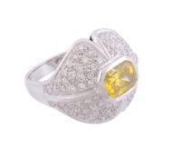 A diamond and yellow diamond dress ring  , the central mixed cut yellow diamond within a pave set