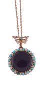 A turquoise and seed pearl locket pendant,   circa 1900, the circular glazed compartment within a