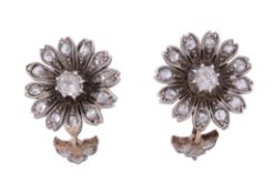 A pair of diamond flower head earrings,   circa 1900,    the flower head clusters set with a