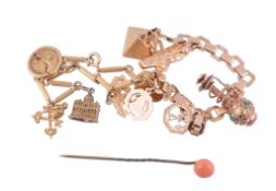 A gold coloured charm bracelet,   the striated baton shaped links suspending five charms including
