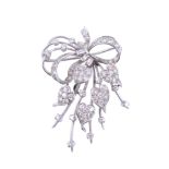 A diamond brooch,   circa 1950,    the ribbon bow design with heart shaped panels set with
