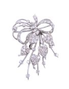 A diamond brooch,   circa 1950,    the ribbon bow design with heart shaped panels set with