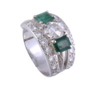 A diamond and emerald dress ring,   circa 1950, the principal old brilliant cut diamond estimated