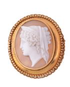 A shell cameo brooch,   circa 1870, carved with the profile of Hera wearing a diadem, within a gold
