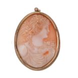 A shell cameo brooch  ,circa 1900, the oval shell carved with the profile of Flora, with flowers in