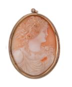 A shell cameo brooch  ,circa 1900, the oval shell carved with the profile of Flora, with flowers in
