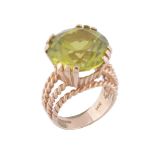 A peridot dress ring,   the circular shaped peridot in a claw setting, with ropetwist detail