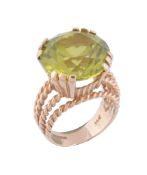A peridot dress ring,   the circular shaped peridot in a claw setting, with ropetwist detail