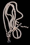 A three strand cultured pearl necklace,   composed of three strands of slightly graduated cultured