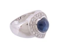 A sapphire and diamond ring,   the central heart shaped sapphire within a surround of brilliant cut