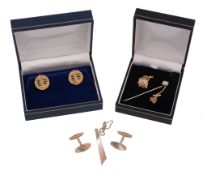 A pair of gold coloured cufflinks,   the pierced circular panels with textured detail, with t bar