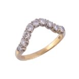 An 18 carat gold diamond wishbone ring,   set with nine brilliant cut diamonds, stamped 750 with