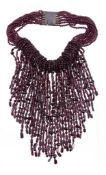 A garnet torsade necklace,   the multi strand necklace composed of vari cut polished garnet beads